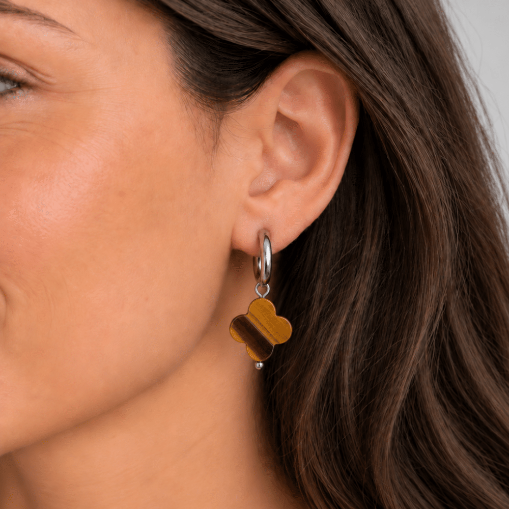 Boucles d’oreilles trèfle en œil de tigre portées à l’oreille